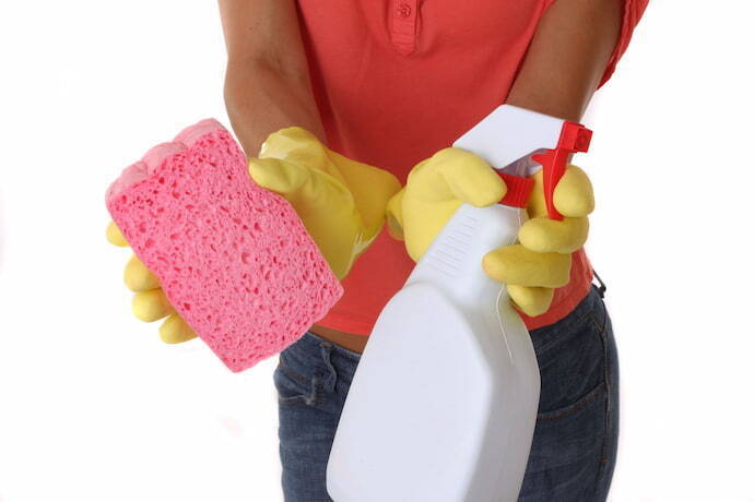 Mulher segurando produtos de limpeza