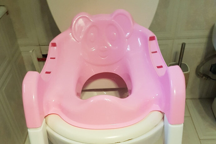 redutores de assento rosa enfeitado com ursinho