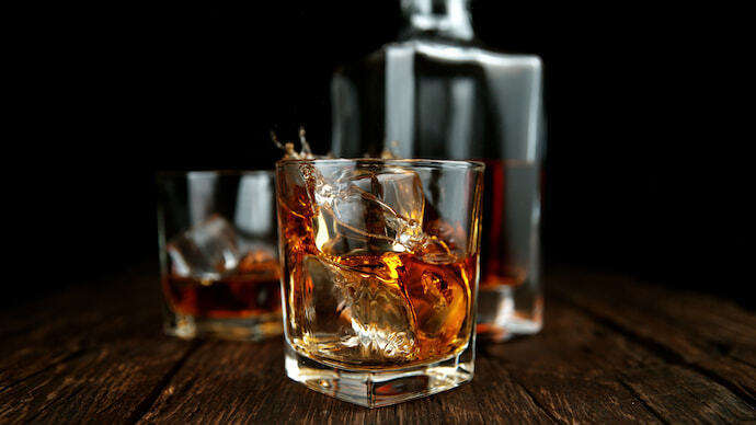 Garrafa e copos com whisky