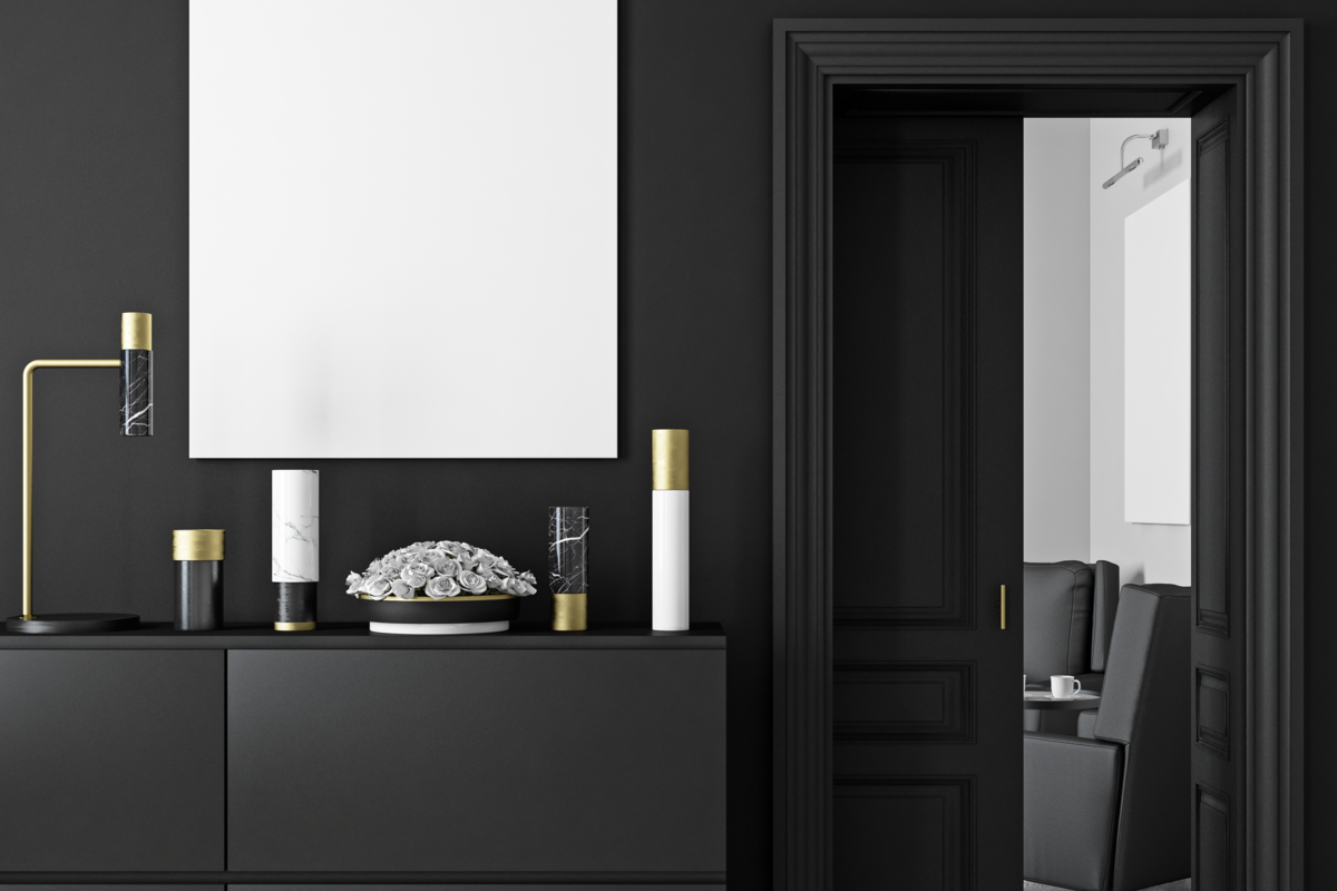 Um quarto moderno com parede e móveis pretos e um quadro branco
