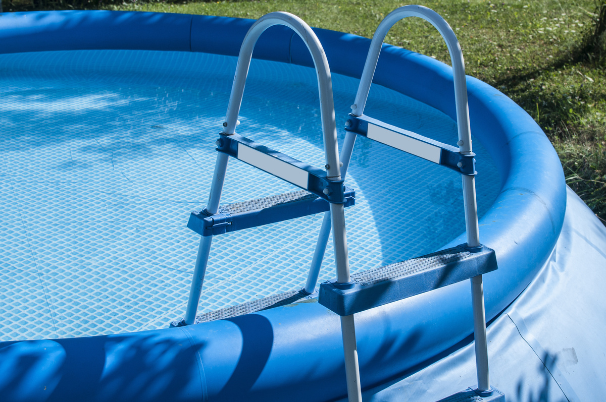 Uma piscina inflável com água e uma escada