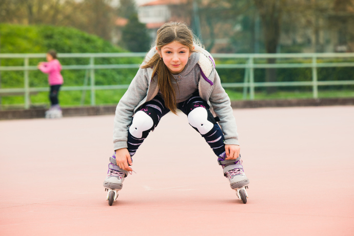 Menina usando um patins Inline no parque