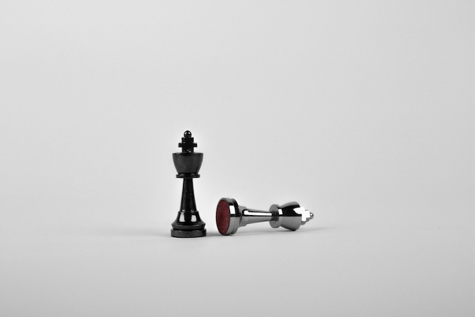Duas peças de xadrez de prata na superfície branca