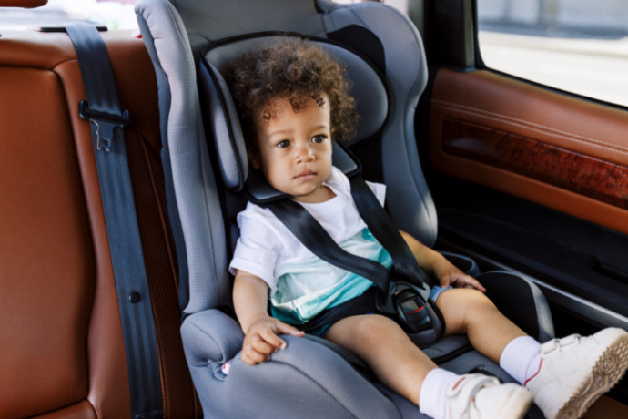 Criança sentada na cadeira para auto